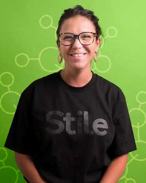 A black & white portrait of Stile team member Patty Luna smiling at the camera