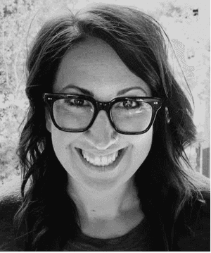 A black & white portrait of Stile team member Shawna Jensen smiling at the camera