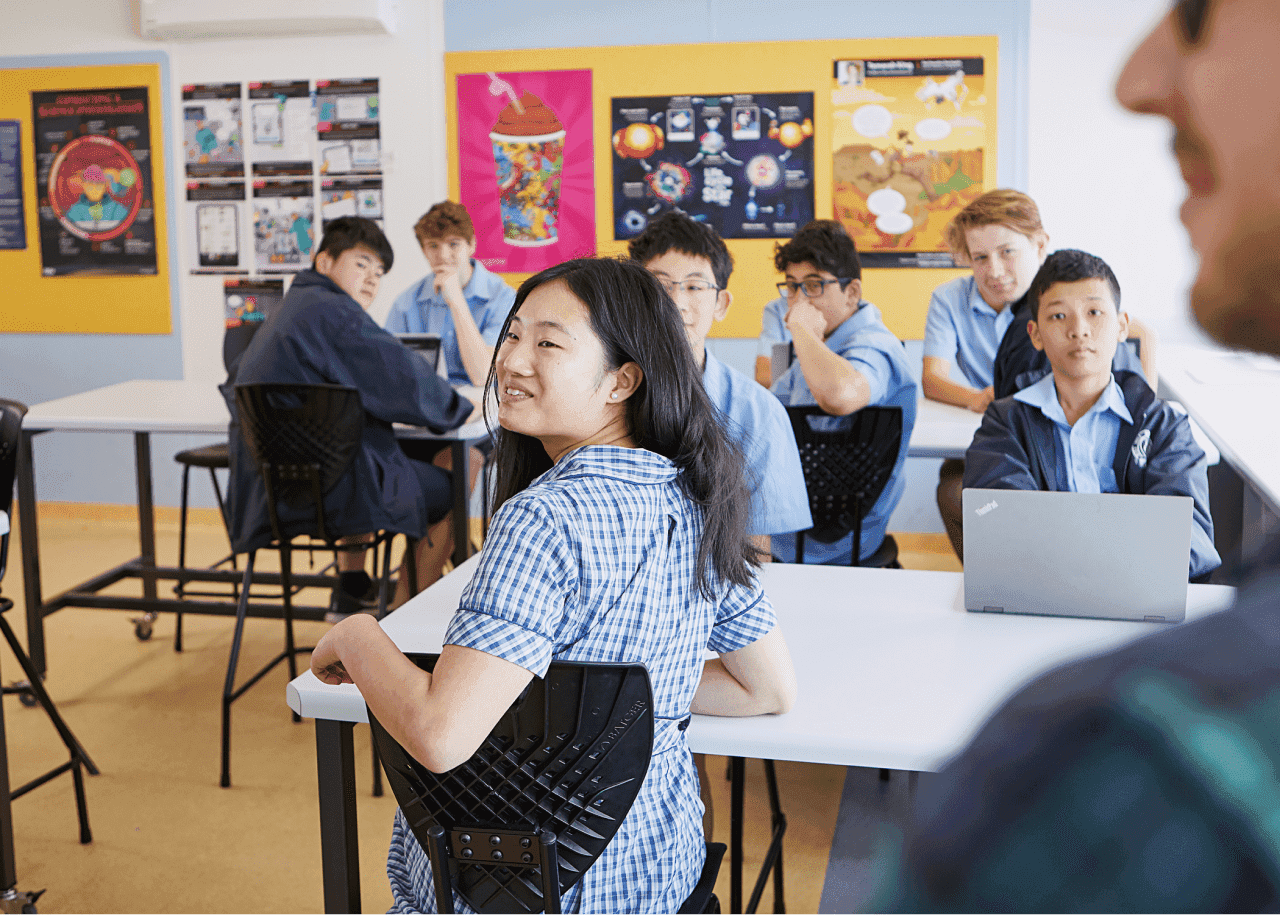 A classroom of students, all focused on someone offscreen