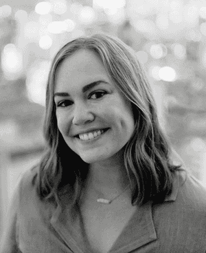 A black & white portrait of Stile team member Hailey Vogel Carvajal smiling at the camera