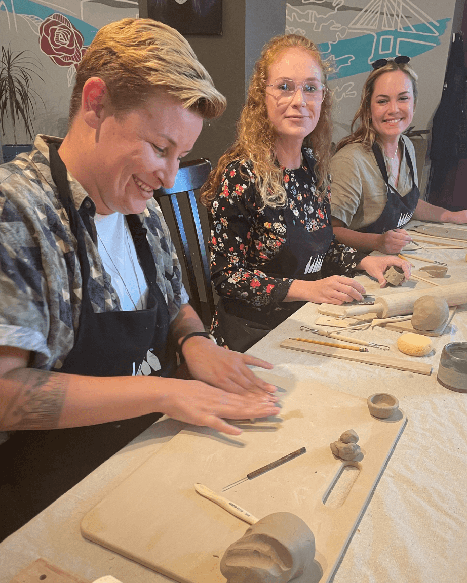 Three Stile staff doing a pottery workshop together