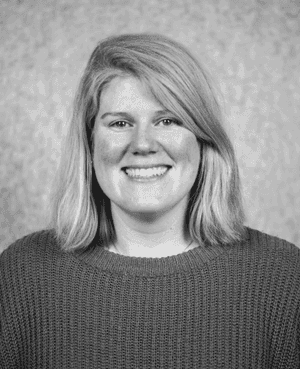 A black & white portrait of Stile team member Clare Feeney smiling at the camera