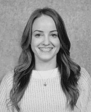 A black & white portrait of Stile team member Meghan Fennessy smiling at the camera