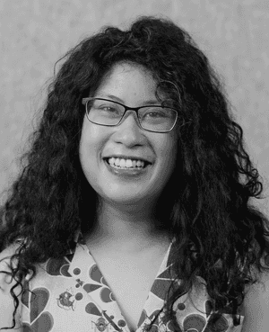 A black & white portrait of Stile team member Quynh-Chi Nguyen smiling at the camera