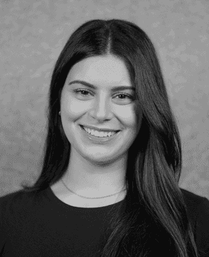 A black & white portrait of Stile team member Daniela Haddad smiling at the camera