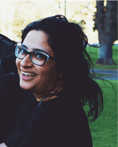 A headshot of a woman smiling over at the camera