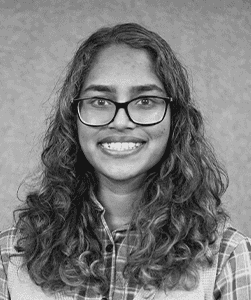 A black & white portrait of Stile team member Chamathi Gamage smiling at the camera