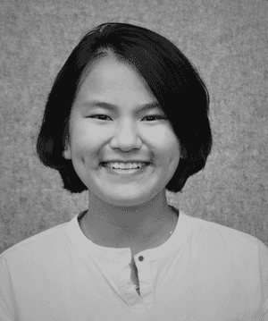 A black & white portrait of Stile team member Emma Ngo smiling at the camera