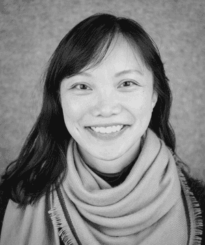 A black & white portrait of Stile team member Emily Cheng smiling at the camera