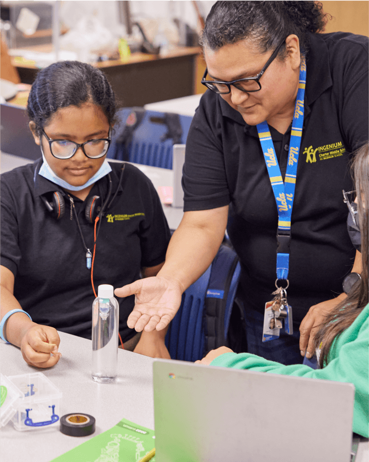 A teacher explaining an experiment to a student