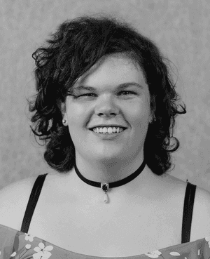 A black & white portrait of Stile team member Ally Macdonald smiling at the camera