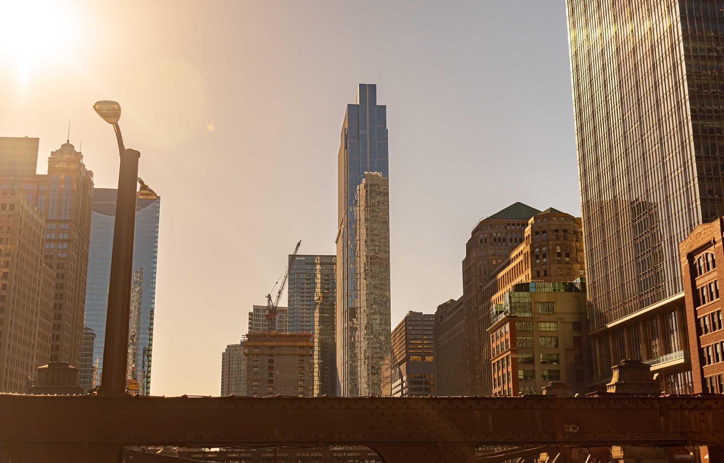 The Chicago skyline at sunset with warm light on downtown buildings.