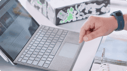 A closeup of a hand poised above a laptop